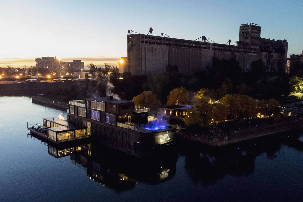 Bota Bota floating spa illuminated at dusk on the St. Lawrence River in Montreal